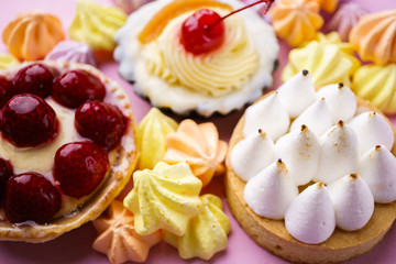 dessert background. delicious assorted cakes. cream cheese cupcake, berry tart, lemon meringue tart. sweet treats and cookies, confectionery