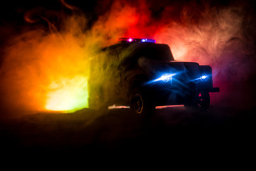 Obraz na płótnie Canvas Police cars at night. Police car chasing a car at night with fog background. 911 Emergency response