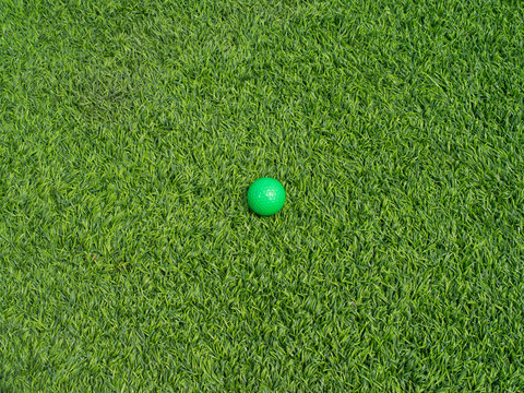 Green golfball on turf