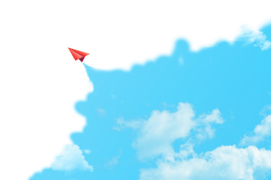 Business Creative and Idea Concept : Red paper plane flying in blue sky surrounded with white clouds.