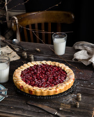 Cherry pie on wooden rustic table