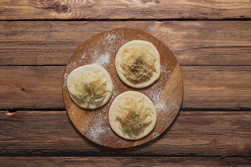Fototapeta premium Cooking pies with cabbage. Rustic cuisine. 