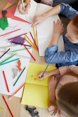 Above view portrait of two girls making handmade cards for holiday, copy space