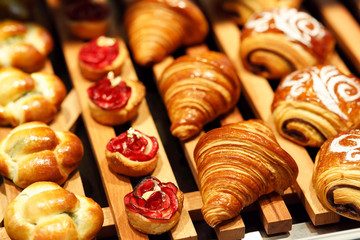 freshly baked pastry on display in bakery shop