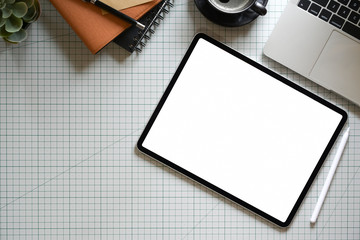Top view tablet with supplies on designer office desk
