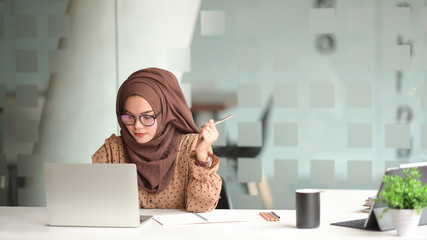 Attractive muslin woman working in office