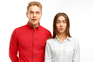 Surprised European partners, shows empathy, amazed by terrible news or revelation, impressed with something, isolated white background in studio