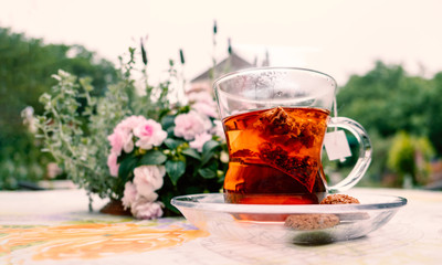 English style afternoon hot herbal tea with cookies at the backyard garden