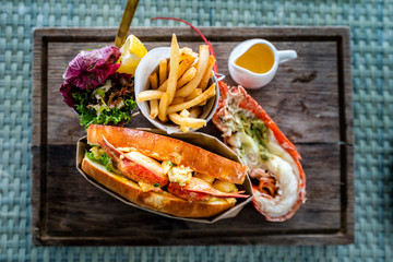 Delicious lobster roll sandwich Served with a side of French Fries and fresh salad. New England lobster roll