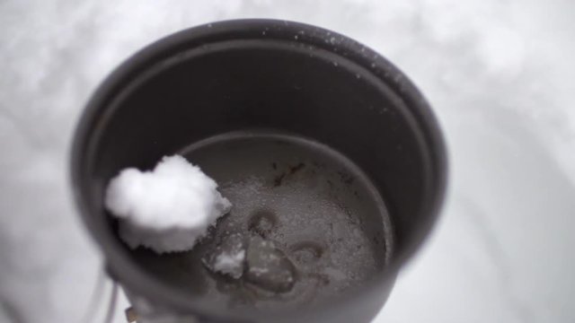 Melting Snow for Water in the Snow Covered Winter Backcountry Mess Kit Pot on Burner Ski Adventure USA Super Slow Motion HD 240fps