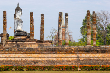 Fototapeta na wymiar Buddha statues at Wat Mahathat ancient capital of Sukhothai, Thailand. Sukhothai Historical Park is the UNESCO world heritage