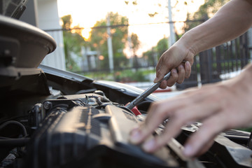 Mechanic, technician man holding spanner checking car engine. car service, repair, fixing, checking...