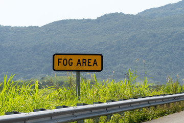 Fog Area road sign/street sign on highway through countryside