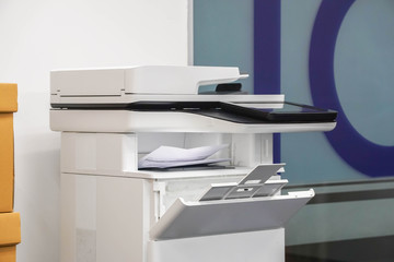 close up multifunctional office laser printer for use in scanning and printing business documents in workplace