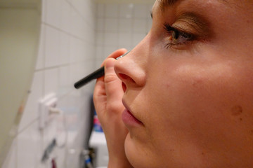 Stockholm, Sweden  A 24 year old woman puts makeup on before going out on a Saturday night.