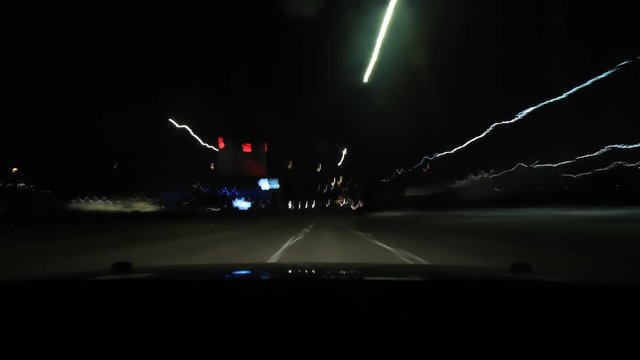 Time lapse footage of a night time city drive