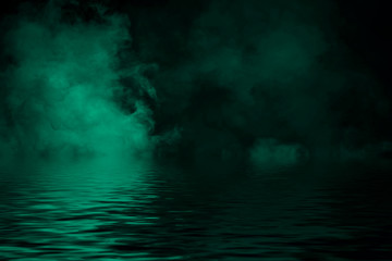 Coastal fog . Green smoke on the shore . Water reflection .