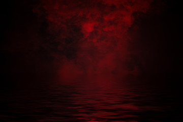 Fototapeta premium Coastal fog . Red smoke on the shore . Water reflection .