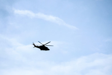 Flight of the helicopter,on sky background