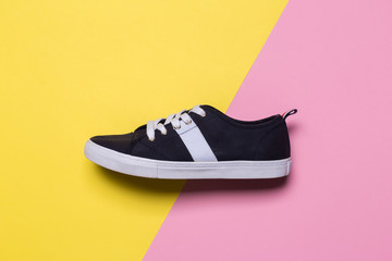 Sneakers on pink and yellow background. Fashion blog or magazine concept.