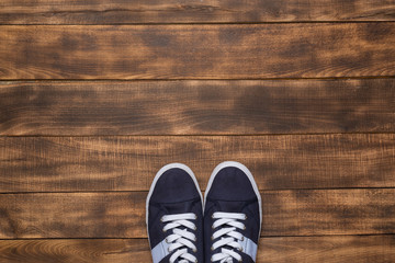 Sneakers on wooden background. Fashion blog or magazine concept.