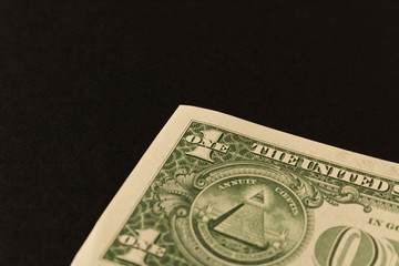 1 dollar bill on a dark background . Close up. The concept of saving money.