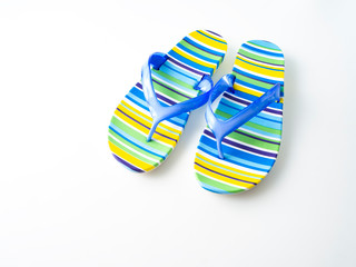 Colorful striped flip flops on white background