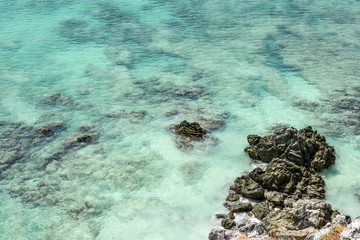 Fototapeta na wymiar Exotic view of emerald sea water and rocks near coral diving site of Andaman sea. Shot from higher ground.