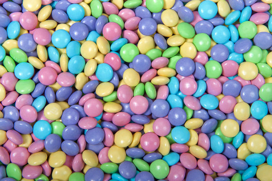 Close up background of candy coated chocolates in pastel colors, Easter theme