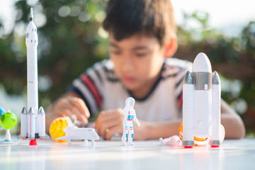 Little boy playing space ship and planet galaxy toy