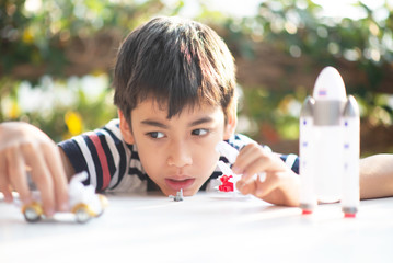 Little boy playing space ship and planet galaxy toy