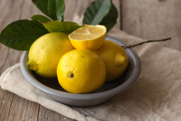 Lemon and half of lemon on brown background. Lemon on brown wooden table