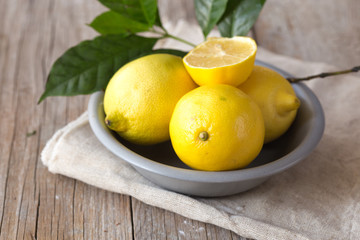 Lemon and half of lemon on brown background. Lemon on brown wooden table