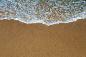 Fototapeta na wymiar Wave of the ocean on the sand