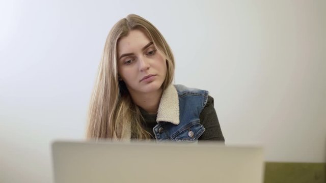 Pretty girl works with laptop in home. 4K