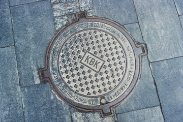 manhole on the background of gray paving slabs