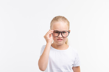 Fototapeta premium Beautiful child girl with glasses isolated on white