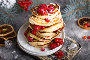 Pancakes with berry on White stone Background, Christmas Dessert. 