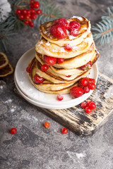 Pancakes with berry on White stone Background, Christmas Dessert. 