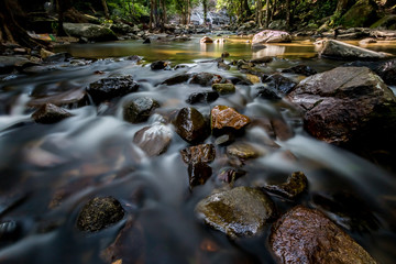 Long exposure shot.Waterfall with rocks in rainforest.