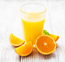 Glass of juice and orange fruits
