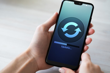 Software Update downloading progress on smartphone screen. Internet and technology concept.