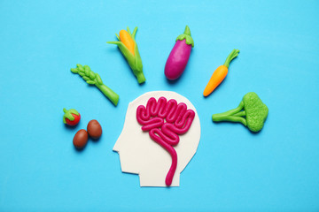 Plasticine figure of man and vegetarian food. Food for mind, charge of energy. Healthy lifestyle,...