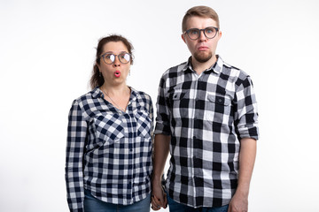 Fototapeta premium Nerds, geek, bespectacled and funny people concept - a couple of nerds in glasses on white background