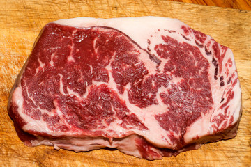 Raw marble beef steak on wooden  cutting board