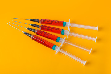 Medical syringes on orange