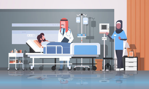 arab doctor and nurse in hijab visiting patient man lying bed with dropper intensive therapy ward healthcare concept hospital room interior medical clinic horizontal full length