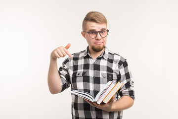 People, knowledge and education concept - Smart man point on books in his hands over white background.