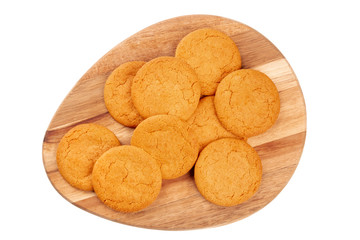 Ginger cookies on a wooden tray, shot from the top, isolated on a white background with a clipping path