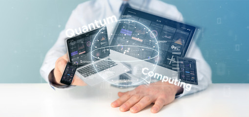 Businessman holding Quantum computing concept with qubit and devices 3d rendering